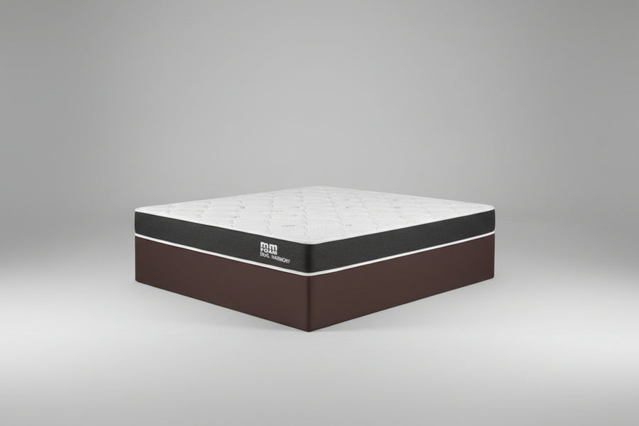 Mattress in a bedroom setting with a plant and lamp